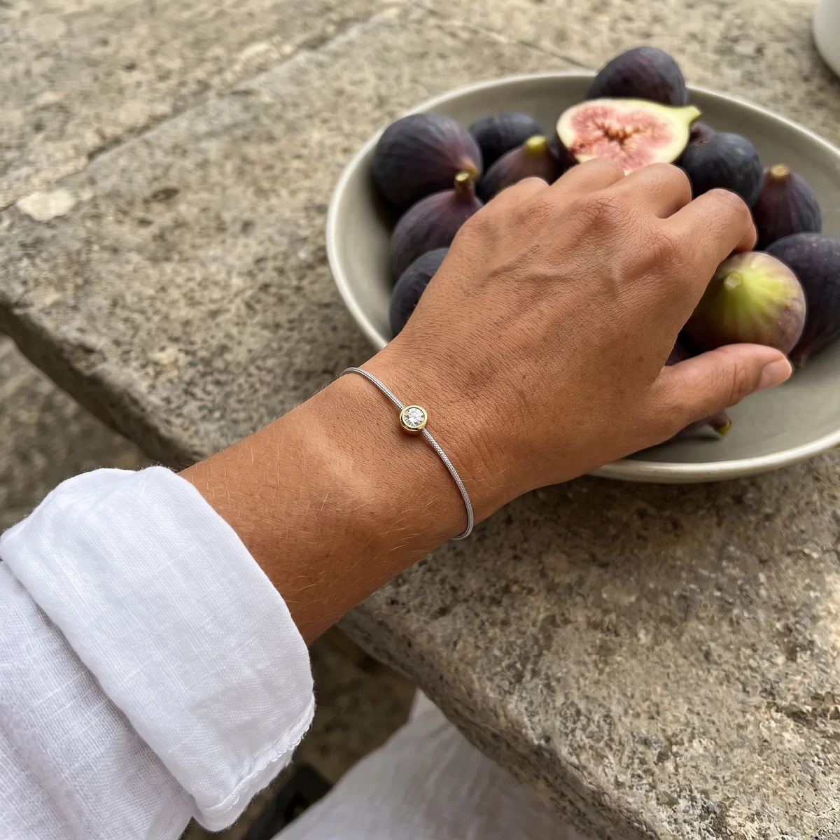 A Mossante cord bracelet worn on the wrist