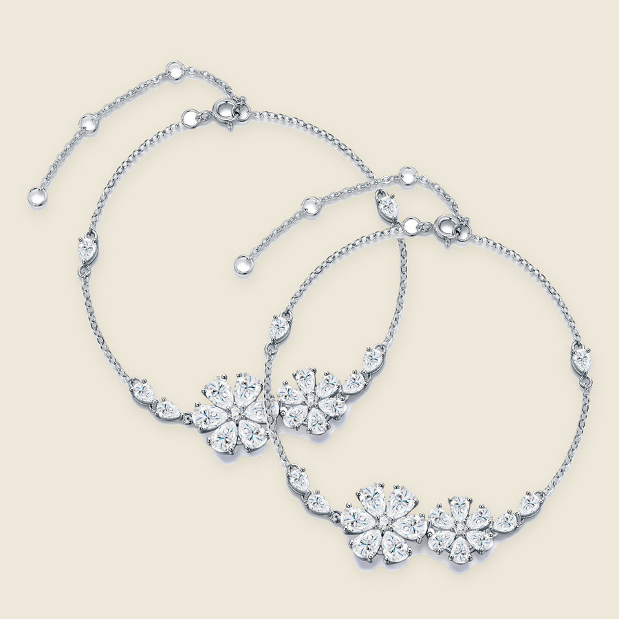 Two floral bracelets laid side by side on a cream ground.