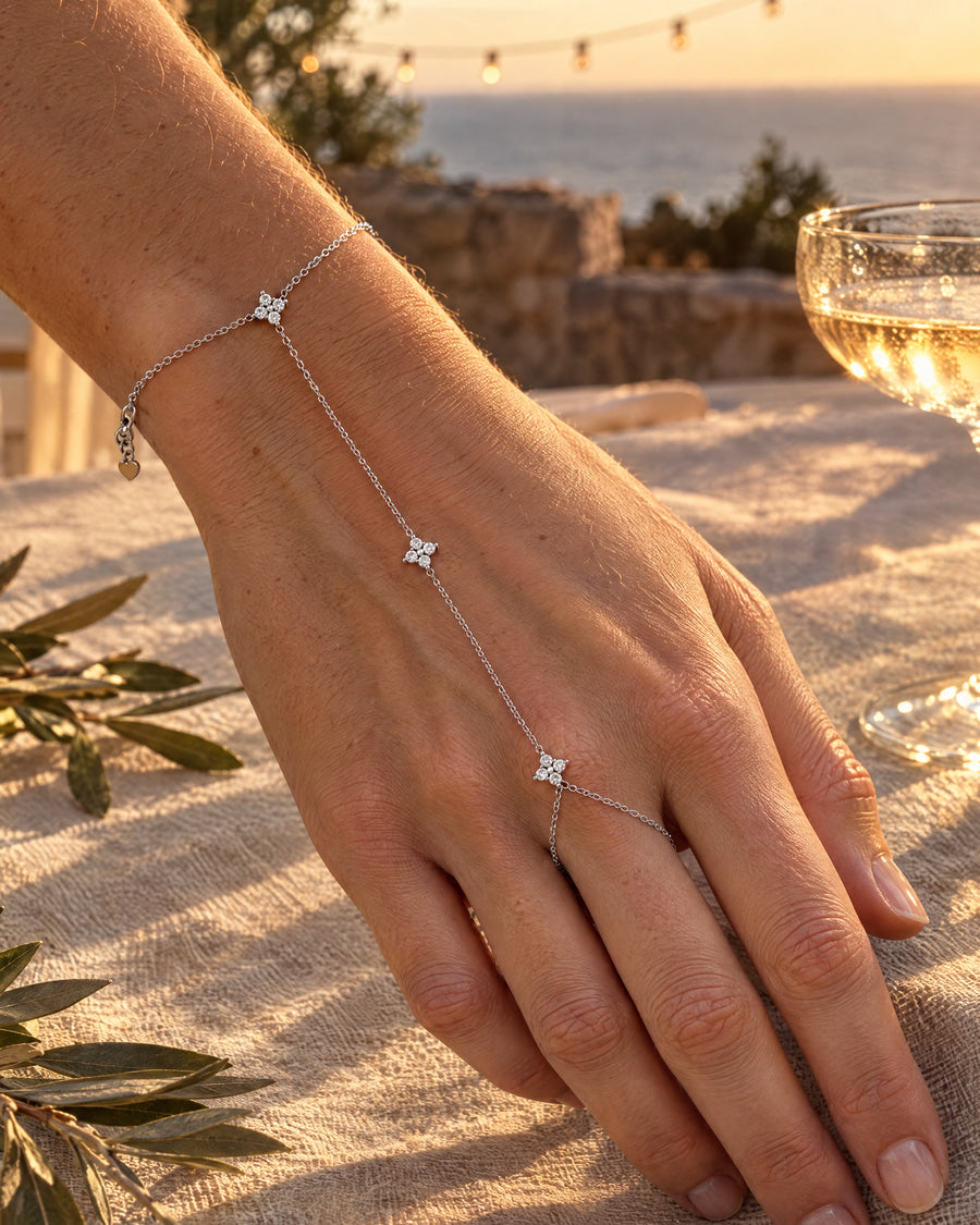 A woman's hand on a linen tablecloth at dusk, the three stars in a line.