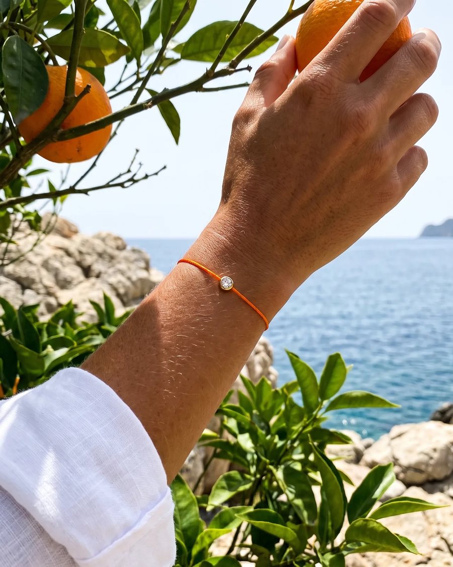 The Orange bracelet worn beside oranges by the sea