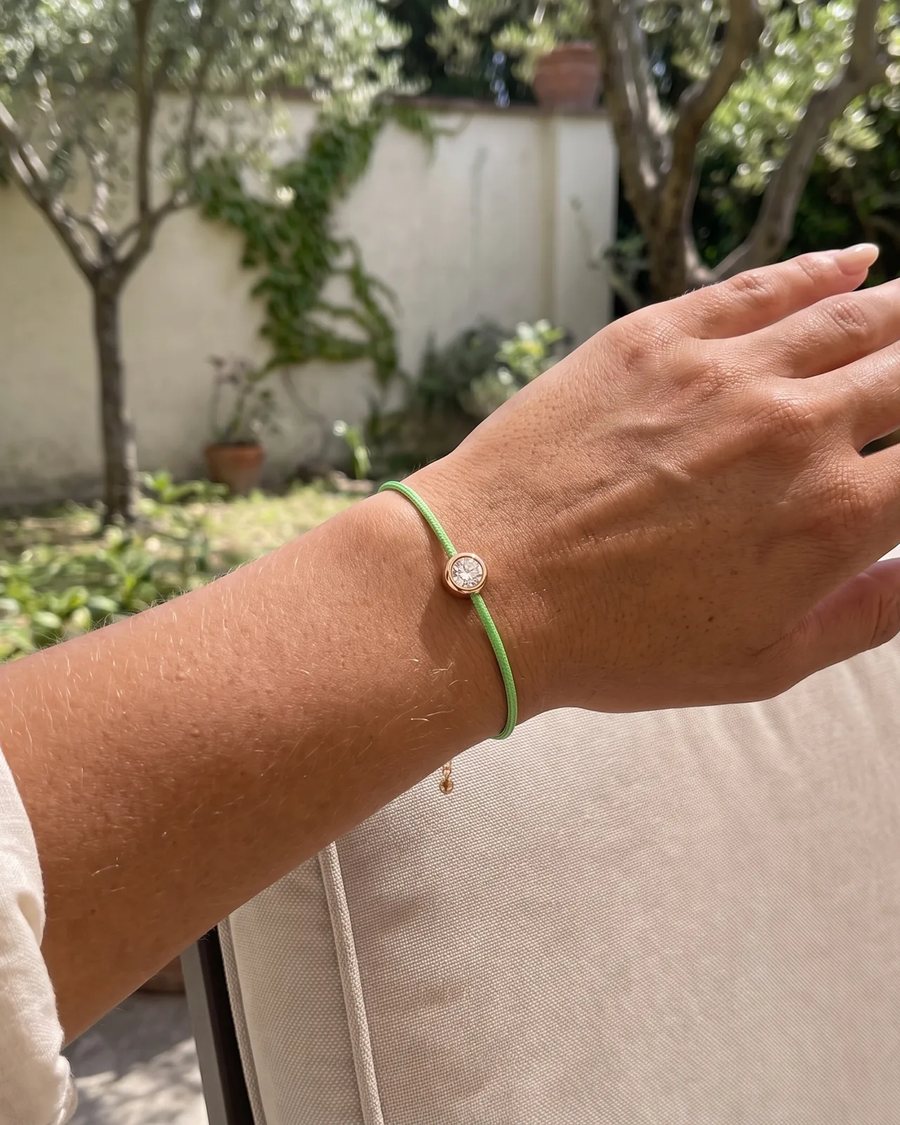 The Green bracelet worn in a garden